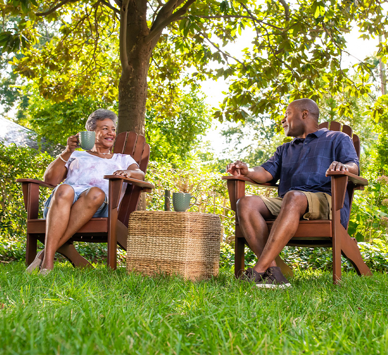 Couple sitting in chairs on their lawn